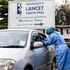 A health worker at Lancet Kenya collects samples for testing Covid-19 from a motorist 