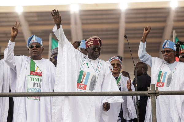 All Progressive Congress (APC) leader and President-elect Bola Tinubu (centre) and President of Nigeria Muhammadu Buhari