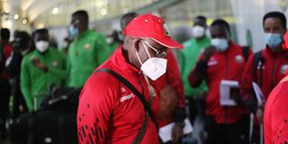 Harambee Stars coach Jacob "Ghost" Mulee leads his team to Jomo Kenyatta International Airport. 
