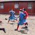 Learners run to class after break time at Star of Hope Primary in Industrial Area
