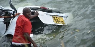 Rescuers retrieve a car from the ocean in Mombasa