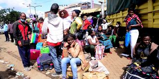 People wait to travel to western Kenya from Machakos Country Bus Station in Nairobi on December 20, 2020.