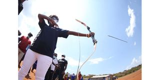 Irene Limika, a former athlete, plays archery at Saikeri Primary School in Kajiado County