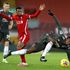 Liverpool midfielder Georginio Wijnaldum (centre) fouls Manchester United midfielder Paul Pogba