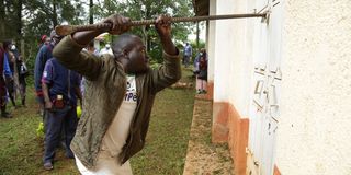 A man tries to break a padlock at St. Paul ACK Yala to enter the church on January 17, 2020.