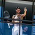 Men's world number one tennis player Novak Djokovic of Serbia gestures to fans from a hotel balcony in Adelaide, South Australia
