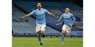 Manchester City midfielder Ilkay Gundogan (left) celebrates scoring his team's third goal