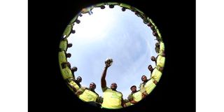 Dan Sikuta holds a rugby ball as the Kabras Sugar Rugby team pose for a group photo