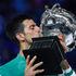 Serbia's Novak Djokovic kisses the Norman Brookes Challenge Cup trophy following his victory