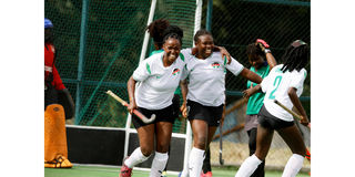 Kenya women hockey team player Caroline Guchu (left) celebrates with teammate Flavia Mutiva after scoring 