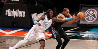 Montrezl Harrell #15 of the Los Angeles Lakers and Kevin Durant #7 of the Brooklyn Nets fight for the ball