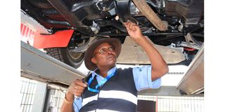 Chief scrutiniser Musa Locho inspects one of the rally cars 
