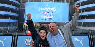 Manchester City fans, Ian Leonard and his son Jack celebrate winning the Premier League title