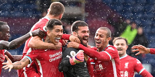 Liverpool golakeeper Alisson celebrates scoring