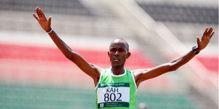Collins Koros of Kahawa crosses the finishing line to win the men's 10,000m race