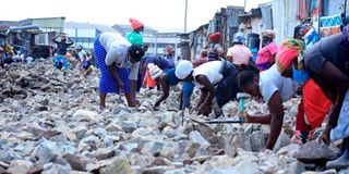 Workers fix the Enterprise-Gatoto road in Mukuru Kwa Reuben