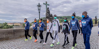Athletes take a walk on Charles Bridge in Prague, Czech Republic