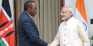 Kenya's President Uhuru Kenyatta (left) shakes hands with India's Prime Minister Narendra Modi