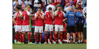 Players gather as paramedics attend to Denmark's midfielder Christian Eriksen