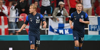 Finland's forward Joel Pohjanpalo (left) gestures after scoring the opening goal