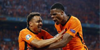 Denzel Dumfries of Holland is congratulated by teammate Donyell Malen