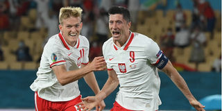 Poland's forward Robert Lewandowski (right) celebrates