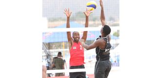 Kenya's Enock Mogeni blocks a spike from Mozambique's Jorge Monjane during their CAVB Continental Cup 