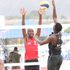 Kenya's Enock Mogeni blocks a spike from Mozambique's Jorge Monjane during their CAVB Continental Cup 