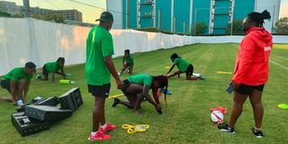 Members of the national women’s rugby team train in Tokyo under strength and conditioning coach Samuel Kimotho