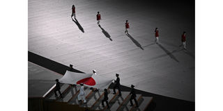 Japan's national flag is carried during the opening ceremony of the Tokyo 2020 Olympic Games