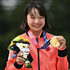 Japan's Momiji Nishiya poses with her gold medal during the podium ceremony 
