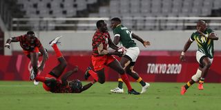 Kenya's Collins Injera heads for the try line 