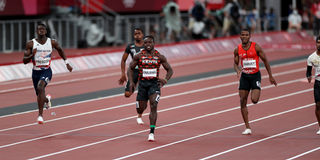 Ferdinand Omanyala Omurwa (centre) of Kenya competes in the men's 100m Heat 5