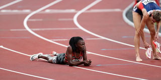 Kenya's Mary Moraa (left) lies flat on the track after finishing third in the women's 800m semi-final Heat 1