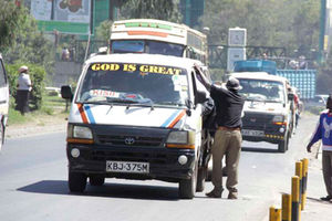 A matatu picking passengers. 