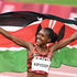 Kenya's Faith Kipyegon celebrates with her flag 