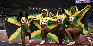 Team Jamaica celebrate gold after the women's 4x100m relay final 