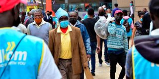 Nairobi residents walk along Tom Mboya Street
