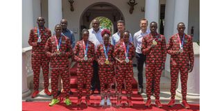 Uhuru Kenyatta, Joe Okudo, Seb Coe pose with Team Kenya medallists