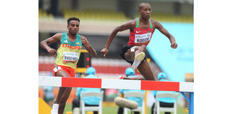 Kenya's Simon Koech (left) clears a hurdle ahead of Ethiopia's Samuel Firewu 