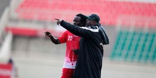 Jacob "Ghost" Mulee (right) gives instructions to midfielder Jackson Macharia