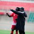 Jacob "Ghost" Mulee (right) gives instructions to midfielder Jackson Macharia