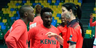 Kenya Morans coach Liz Mills gives instructions to team captain Griffin Ligare and Erick Mutoro 