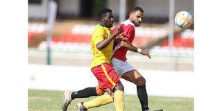 Cameroon’s Nechi Albert vies for the ball with Mohamed Emad of Egypt 