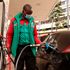 A filling station attendant fueling a car.