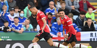 Manchester United's English striker Mason Greenwood celebrates with teammate Jadon Sancho 