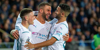 Manchester City's English defender Kyle Walker (centre) celebrates with team mates Phil Foden and Riyad Mahrez
