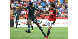 Egypt's forward Mohamed Salah (right) vies for the ball with Nigeria's defender Kenneth Omeruo 