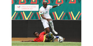 Guinea's midfielder Ilaix Moriba Kourouma (left) vies for the ball with Senegal's forward Mame Thiam