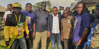 Twaha Mbarak poses with fans during the burial of football fan Isaac Juma